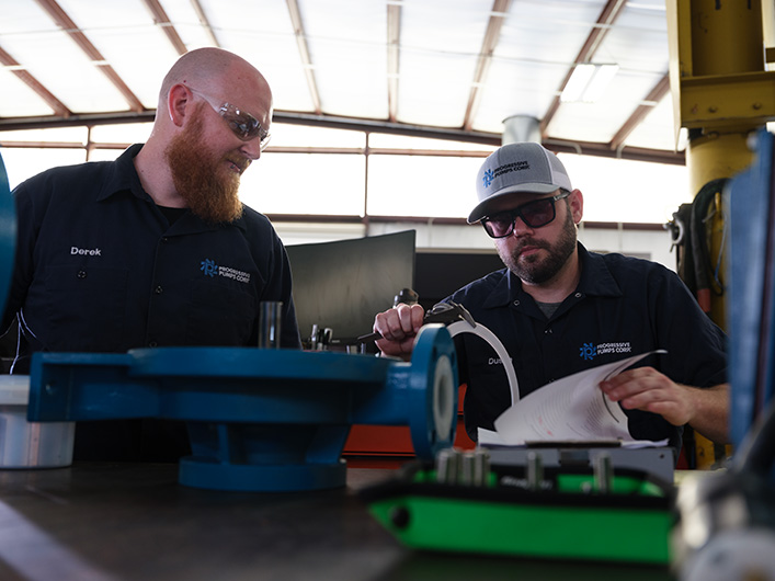 Photo of two employees working together