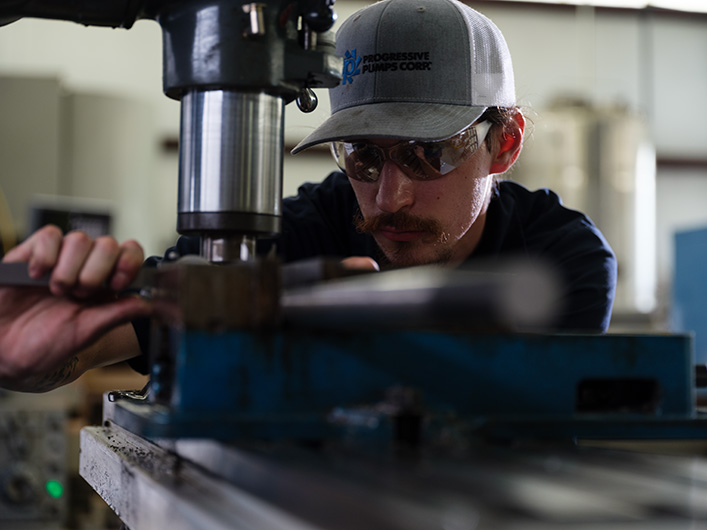 Photo of an employee working on a pump