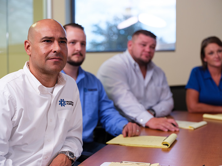 Photo of employees in a board meeting